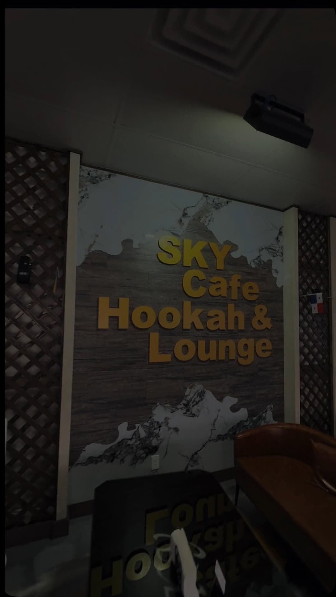 Gold "SKY Cafe Hookah & Lounge" letter wall